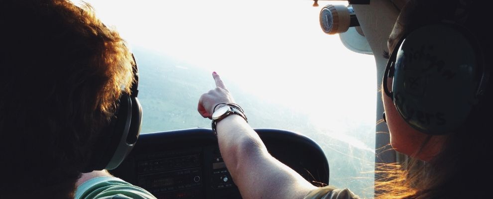 couple in cockpit pointing out ahead